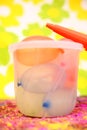 Portrait of water balloons in bucket with pichkari for holi fun.