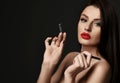 Portrait of wealthy naked luxury woman with red lips and makeup holding cosmetologist tools tweezers for lash and brow