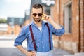 Portrait of weird stylish businessman with banana outdoors