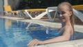 Portrait of the wet young beautiful beauty blonde in pool