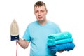 Portrait on white background man with iron and a pile of ironed