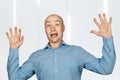 Portrait White bald man in blue shirt got scared and hands up Royalty Free Stock Photo