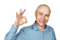 Portrait White bald man in blue shirt on a white isolated background showing sign okay