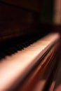 A portrait of the white and black keys of a beautifful old wooden piano. Some of the keys are worn out or have fallen off Royalty Free Stock Photo