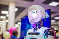 Portrait of white cute humanoid robot at robotic show