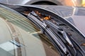 A portrait of a windshield wiper of a car standing at its lowest of base position and the blade is resting on the glass of the Royalty Free Stock Photo