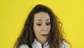 Portrait of woman accidentally did something wrong in Studio with yellow Background.