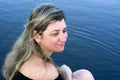 Portrait of woman against river with blue sky glow