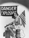 Portrait of woman with American flag and explosives Royalty Free Stock Photo