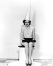 Portrait of woman with April Fool sign wearing dunce cap Royalty Free Stock Photo