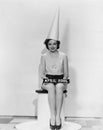 Portrait of woman with April Fool sign wearing dunce cap Royalty Free Stock Photo