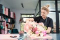 Portrait of woman in apron while creating stylish bouquet Royalty Free Stock Photo