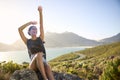 Portrait Of Woman With Backpack On Vacation Taking A Break On Hike By Sea Stretching Arms In The Air Royalty Free Stock Photo