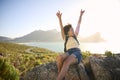 Portrait Of Woman With Backpack On Vacation Taking A Break On Hike By Sea Stretching Arms In The Air Royalty Free Stock Photo