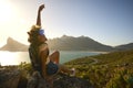 Portrait Of Woman With Backpack On Vacation Taking A Break On Hike By Sea Stretching Arms In The Air Royalty Free Stock Photo