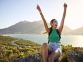 Portrait Of Woman With Backpack On Vacation Taking A Break On Hike By Sea Stretching Arms In The Air Royalty Free Stock Photo