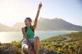 Portrait Of Woman With Backpack On Vacation Taking A Break On Hike By Sea Stretching Arms In The Air Royalty Free Stock Photo