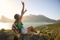 Portrait Of Woman With Backpack On Vacation Taking A Break On Hike By Sea Stretching Arms In The Air Royalty Free Stock Photo