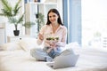 Portrait of woman on bad at home and using laptop while eating healthy salad. Royalty Free Stock Photo