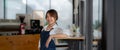 Portrait of woman barista startup successful small Asian business owner in coffee shop.Asian woman barista cafe owner Royalty Free Stock Photo