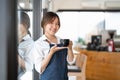 Portrait of woman barista startup successful small Asian business owner in coffee shop.Asian woman barista cafe owner Royalty Free Stock Photo