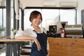 Portrait of woman barista startup successful small Asian business owner in coffee shop.Asian woman barista cafe owner Royalty Free Stock Photo