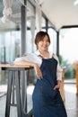 Portrait of woman barista startup successful small Asian business owner in coffee shop.Asian woman barista cafe owner Royalty Free Stock Photo