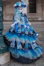 Portrait of woman in beautiful blue costume, hat and mask at the Doges Palace, Venice, during the carnival