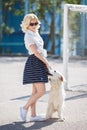 Portrait of a woman with beautiful dog playing outdoors. Royalty Free Stock Photo