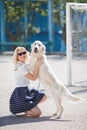 Portrait of a woman with beautiful dog playing outdoors. Royalty Free Stock Photo