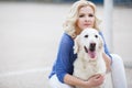 Portrait of a woman with beautiful dog playing outdoors. Royalty Free Stock Photo