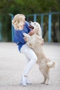 Portrait of a woman with beautiful dog playing outdoors. Royalty Free Stock Photo