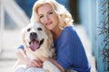 Portrait of a woman with beautiful dog playing outdoors. Royalty Free Stock Photo