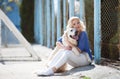 Portrait of a woman with beautiful dog playing outdoors. Royalty Free Stock Photo