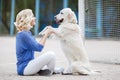 Portrait of a woman with beautiful dog playing outdoors. Royalty Free Stock Photo