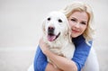 Portrait of a woman with beautiful dog playing outdoors. Royalty Free Stock Photo