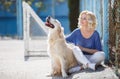 Portrait of a woman with beautiful dog playing outdoors. Royalty Free Stock Photo