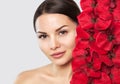 Portrait of a woman with beautiful make-up holds a red orchid in his hands. Royalty Free Stock Photo