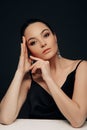 Portrait of woman in black dress with earrings Royalty Free Stock Photo