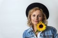 Portrait of a woman with black hat and yellow sunflower Royalty Free Stock Photo