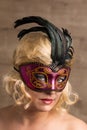 Blonde woman wearing venetian mask with black feathers Royalty Free Stock Photo