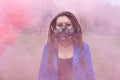 Portrait of a Woman in a blue jacket and dreadlocks in a gas mask with spikes. woman standing in smoke Royalty Free Stock Photo