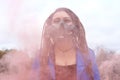 Portrait of a Woman in a blue jacket and dreadlocks in a gas mask with spikes. woman standing in smoke Royalty Free Stock Photo