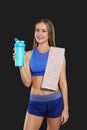 Portrait of woman with bottle of protein shake