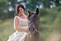 Portrait of a woman with bridal dress and Andalusian horse Royalty Free Stock Photo