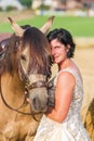 Portrait of a woman with bridal dress and Andalusian horse Royalty Free Stock Photo