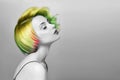 Portrait of a woman with bright colored flying hair, all shades of green. Hair coloring beautiful lips and makeup. Hair fluttering