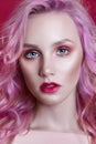 Portrait of a woman with bright colored flying hair, all shades of pink purple. Hair coloring, beautiful lips and makeup. Hair Royalty Free Stock Photo