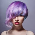 Portrait of a woman with bright colored flying hair, all shades of purple. Hair coloring, beautiful lips and makeup. Hair Royalty Free Stock Photo