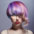 Portrait of a woman with bright colored flying hair, all shades of purple. Hair coloring, beautiful lips and makeup. Hair